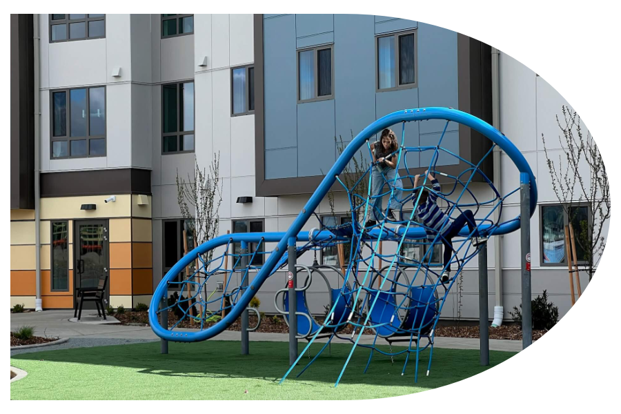 The Millworks Exterior Children playing on the playground of The Millworks